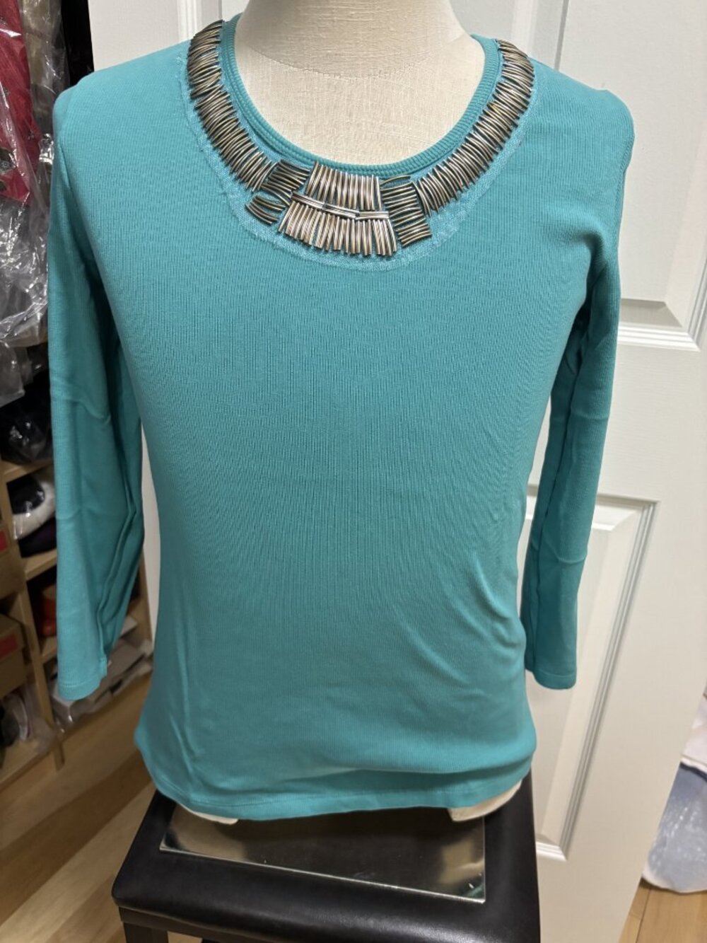 Silver beaded neckline on turquoise long 3/4 sleeve top
